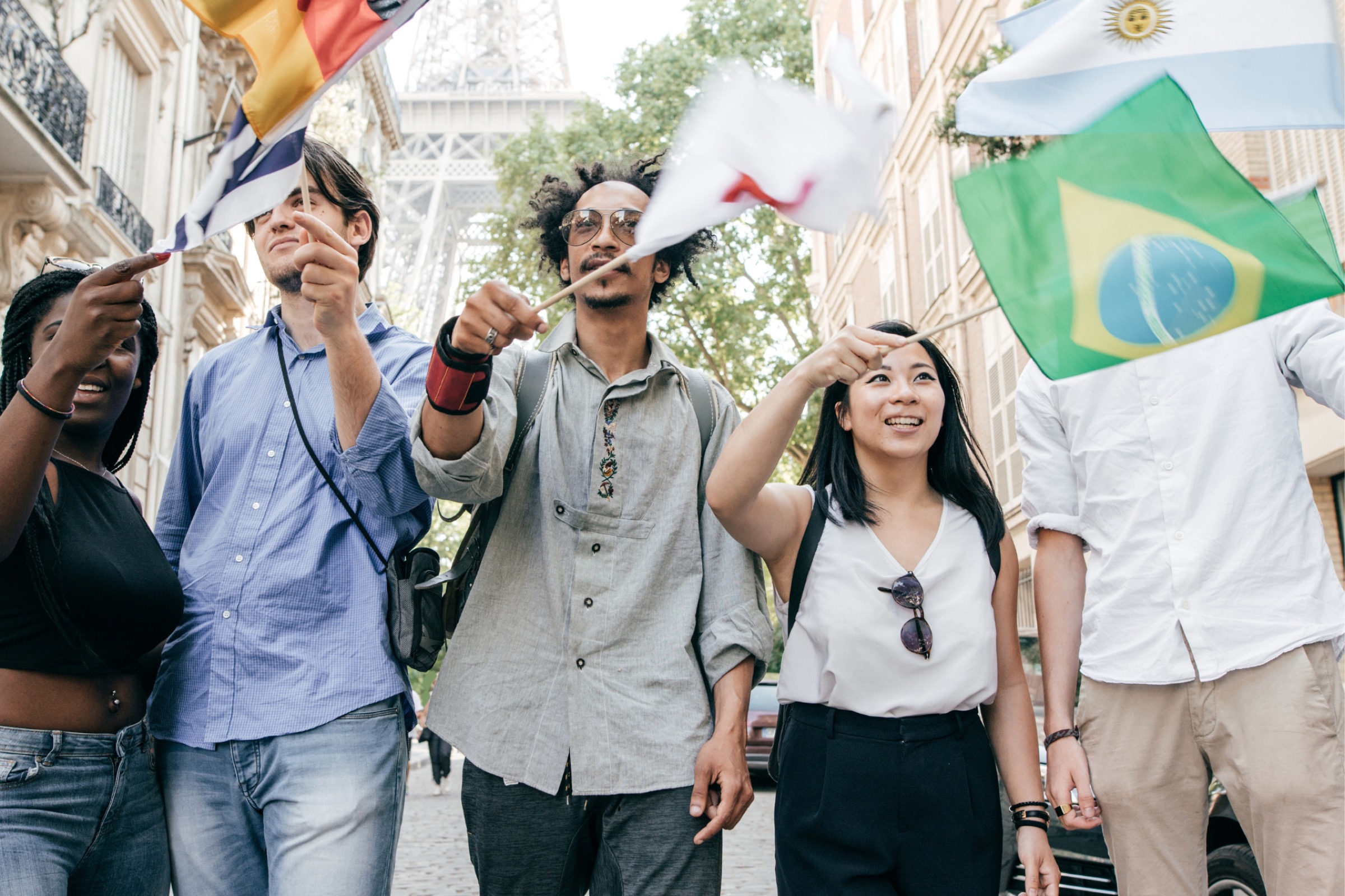 Group waving flags in street